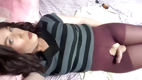 Shemale gets naked and masturbates in front of a mirror