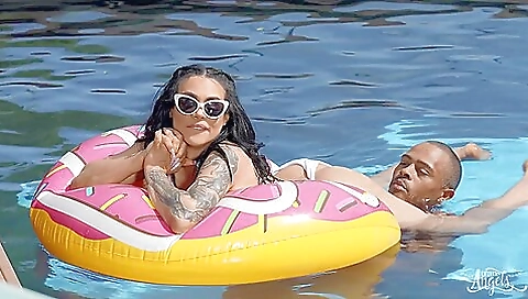 Tattooed girl with a nice body is having fun outdoors